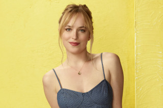 Woman blue top yellow wall - a yellow wall free wallpaper