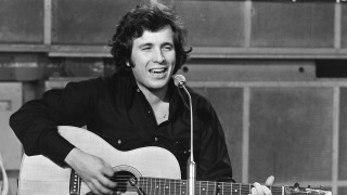 Man holding guitar singing into 2 - david brewster free wallpaper