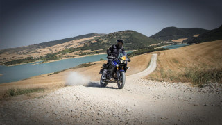 Man motorcycle dirtroad lake mountains - mannerism free wallpaper