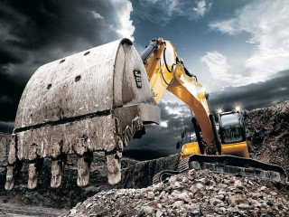 Bulldozer digging rocks cloudy sky - carl hoppe free wallpaper