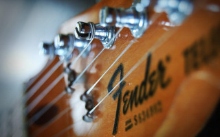Guitar strings closeup logo name - a close up of a guitar free wallpaper