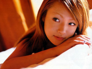Woman laying bed arms crossed 2 - looking free wallpaper