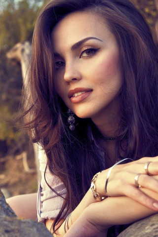 Woman leaning rock hands chest - free portrait wallpaper