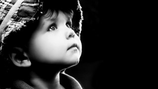Boy wearing hat looking up - his eye wide open free wallpaper
