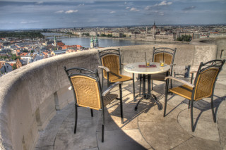 Table chairs balcony cityscape river - a balcony free wallpaper