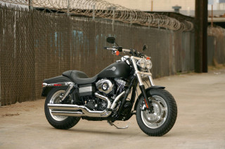Motorcycle parked fence building barbed - dan scott free wallpaper