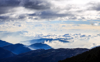 Mountain range bird clouds sky - a view of a mountain range free wallpaper