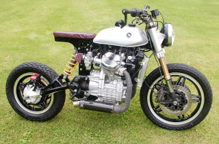 Motorcycle parked green field clock - a motorcycle free wallpaper
