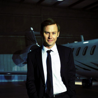 Man suit tie plane hangar - a plane in the background free wallpaper