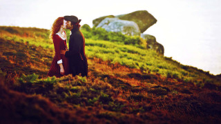 Man woman period clothing kissing - a hill side free wallpaper