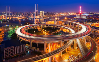 City traffic night bridge lights - a city skyline in the background free wallpaper
