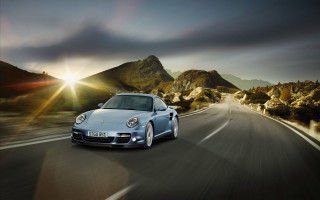 Silver porsche driving road mountains - the background and sun free wallpaper