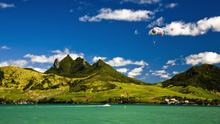 Kite flying water mountains boat - over a body of water free wallpaper