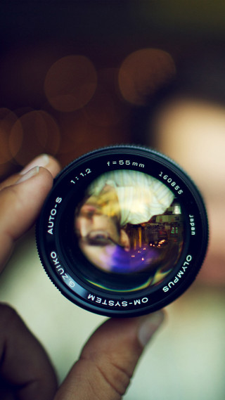 Person holding camera lens blurry - a person holding free wallpaper