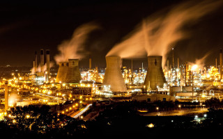 Factory smokestacks night city buildings - a factory free wallpaper
