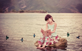 Girl sitting rock reading book - surreal photography free wallpaper