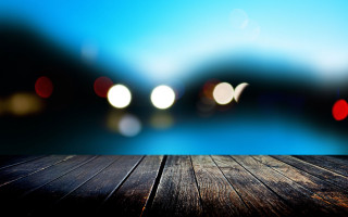Wooden table blurry lights lake 2 - a wooden table free wallpaper