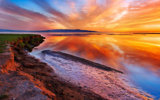 Sunset water rocky shore grassy - a rocky shore free wallpaper