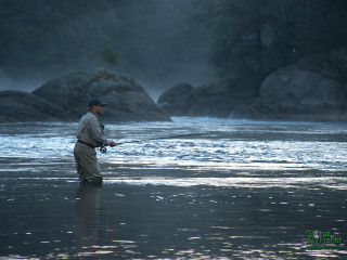 Man standing water holding fish - the water free wallpaper