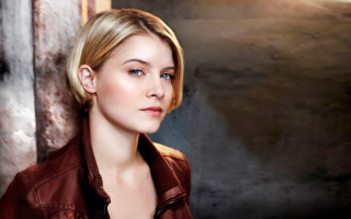 Woman brown jacket studio setting - promotional image free wallpaper