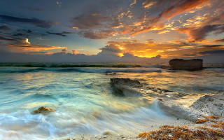 Sunset ocean rocky shore rock - a sunset over the ocean free wallpaper