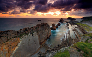 Rocky beach ocean formation sunset - a body of water free wallpaper for desktop