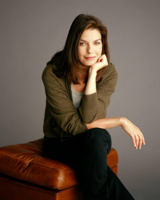 Woman sitting brown chair hand - her chin free wallpaper