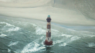 Lighthouse ocean waves blurry sky - aerial free wallpaper
