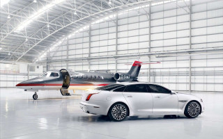 White car parked jet hangar - institutional free wallpaper