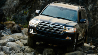 Brown suv rocks mountain rockwall - promotional image free wallpaper for desktop