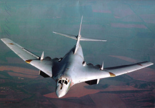 Fighter jet flying green field - matte free wallpaper
