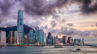 City skyline water mountain clouds - a large body of water in front free wallpaper