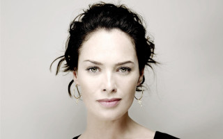 Woman black top earrings white - a gray wall behind her free wallpaper