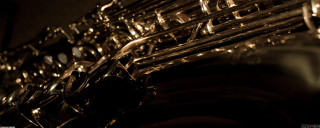 Saxophone closeup black background blurry - biomechanical free wallpaper