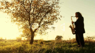 Man playing saxophone field sunset - cinematic photography free wallpaper