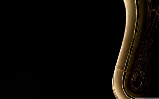 Saxophone closeup black background light - a light reflection free wallpaper