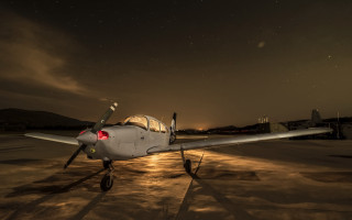 Small airplane night tarmac city - the light free wallpaper