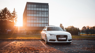White car parking lot building - a parking lot next free wallpaper