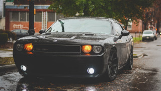 Black car wet street streetlight - a black car free wallpaper