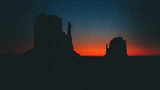 Sunset silhouette rock formation orange - distant free wallpaper