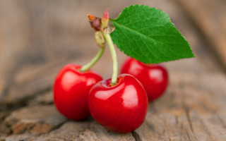 Three cherries green leaf wood - a wooden surface free wallpaper