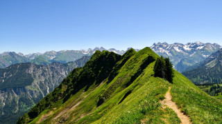 Grassy mountain trail mountain range - a mountain range in the background free wallpaper