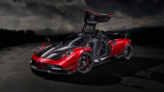 Red sports car dark road - a dark sky in the background free wallpaper