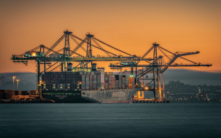Cargo ship sunset cityscape bridge - symmetric balance free wallpaper