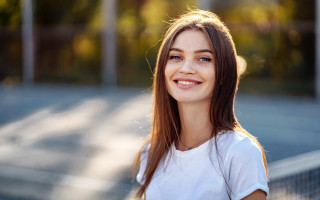 Tennis court woman smiling bokeh - a tennis racket free wallpaper