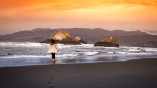Beach woman sunset mountain ocean - a beach next free wallpaper
