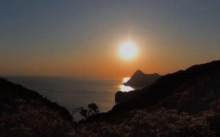 Sunset ocean mountain city lights - a sunset over the ocean free wallpaper