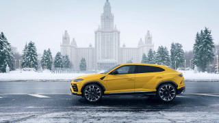 Yellow lamb suv parking building - a parking lot in front free wallpaper