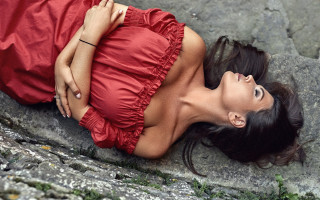 Red dress laying rock portrait - annabel eyres free wallpaper