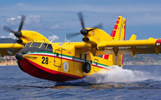 Yellow airplane ocean city boat - over the ocean water free wallpaper